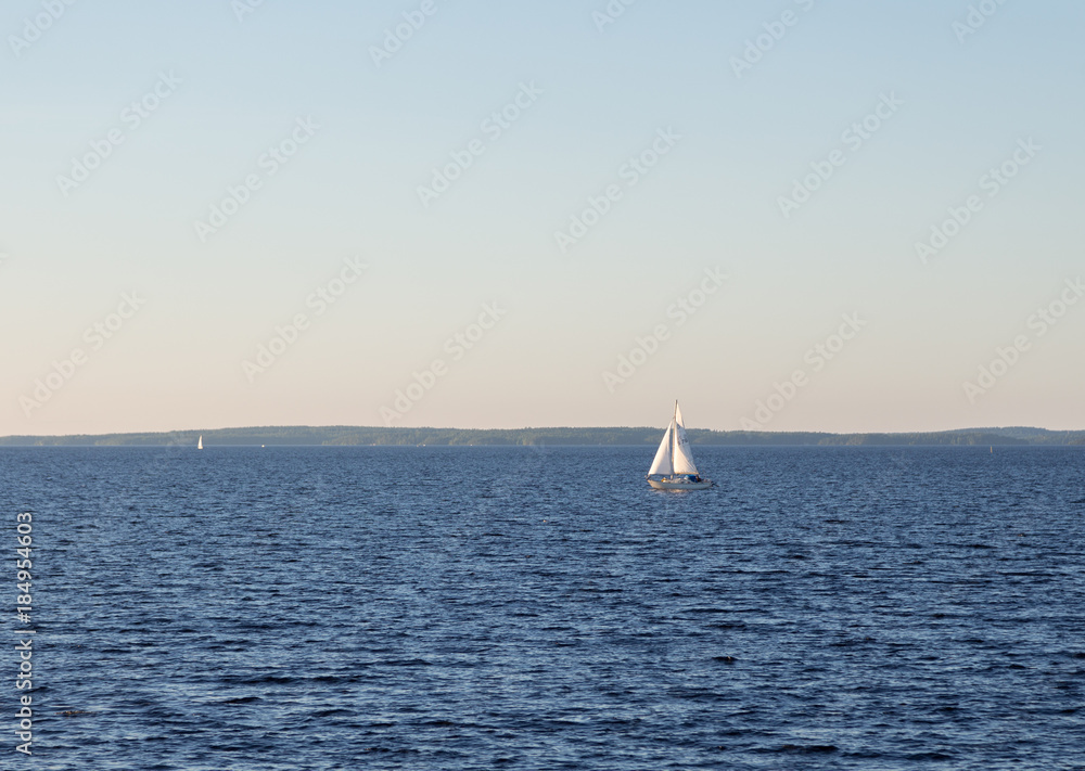 Sailing boat on a calm lake at summer