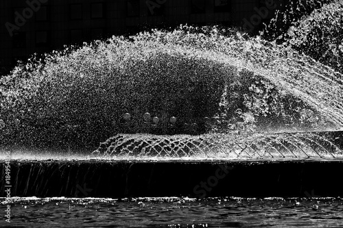 Jets of fountain water frozen in the air. Abstract black and white image.
