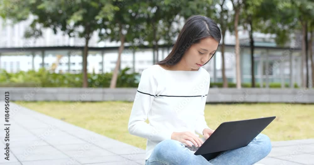 Young Woman using on laptop computer at outdoor Young Woman using on laptop computer at outdoor