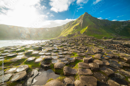 The Giant's Causeway at dawn on a sunny day with the famous basalt columns, the result of an ancient volcanic eruption. County Antrim on the north coast of Northern Ireland, UK photo