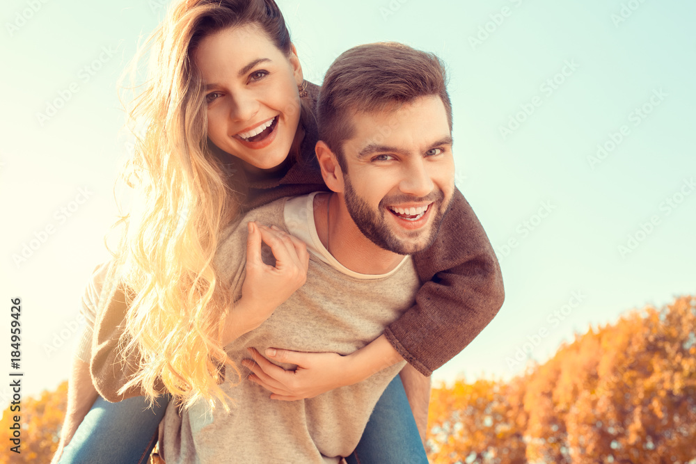 Young couple walk in the autumn park