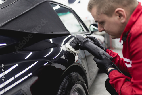 Car detailing - Worker with orbital polisher in auto repair shop.  © hedgehog94