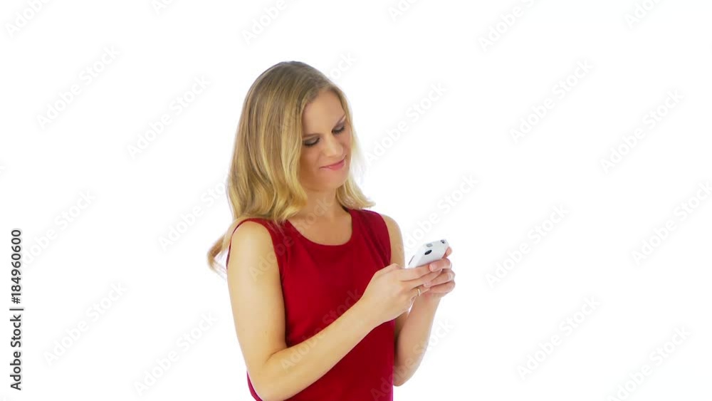 Woman texting and smiling at camera Woman texting and smiling at camera