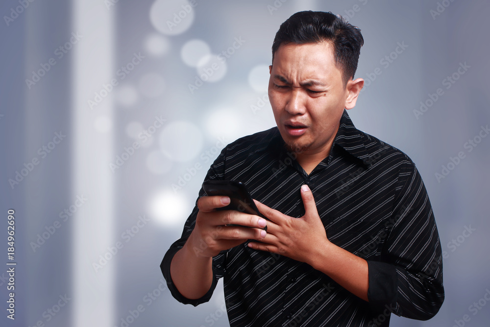 Young Man Texting Reading Chatting on His Phone Sad Crying Young Man Texting Reading Chatting on His Phone Sad Crying