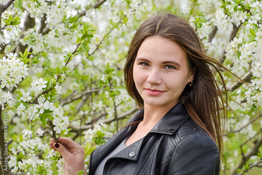 Beautiful fairy young girl in a flowering plum garden. Portrait Beautiful fairy young girl in a flowering plum garden. Portrait