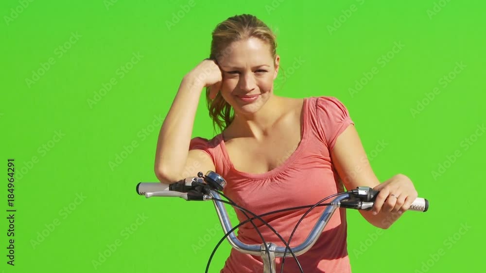Female on bicycle smiling and facing camera Female on bicycle smiling and facing camera