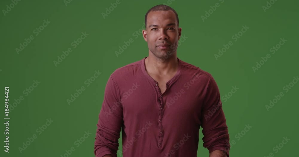 An African American man posing for a portrait on green screen. On green ...