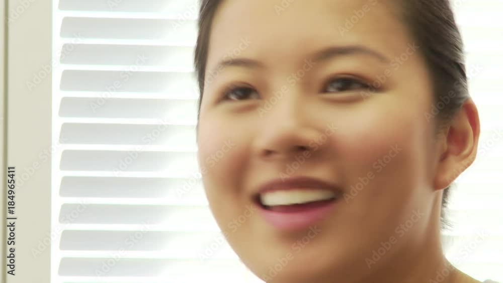 Closeup of young Asian businesswoman talking Closeup of young Asian businesswoman talking