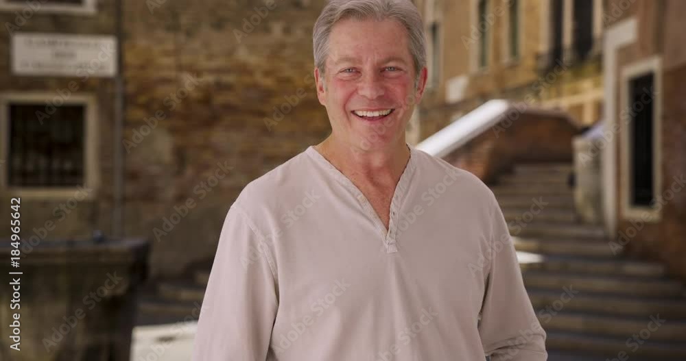 Mature Caucasian man laughing with delight on vacation in Venice Mature Caucasian man laughing with delight on vacation in Venice