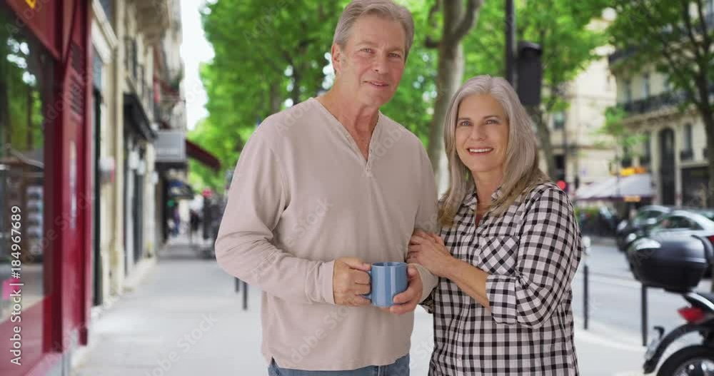 Loving old white couple stands happily on a London sidewalk Loving old white couple stands happily on a London sidewalk