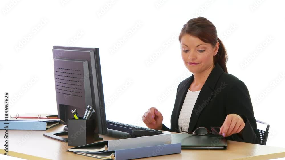 Businesswoman sitting at desk working Businesswoman sitting at desk working