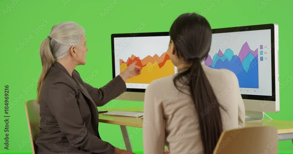 Two office professionals talk about their company's statistics on green screen. On green screen to be keyed or composited. Two office professionals talk about their company's statistics on green screen. On green screen to be keyed or composited.