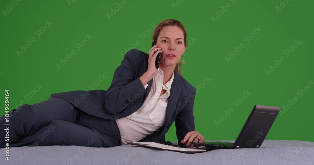 Successful woman in business suit making phone call on green screen. On green screen to be keyed or composited. Successful woman in business suit making phone call on green screen. On green screen to be keyed or composited.