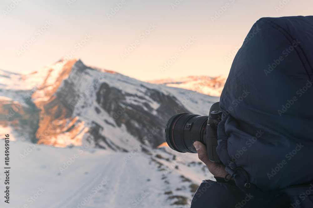 Nature photographer in winter mountains