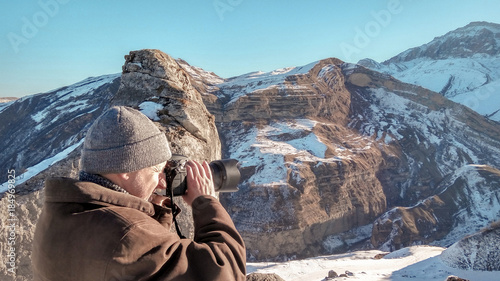 Nature photographer in winter mountains © Vastram