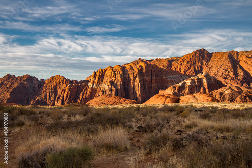 Spectacular sunrise illumination of the Navajo Sandstone mountains of Snow Canyon State Park in Utah.