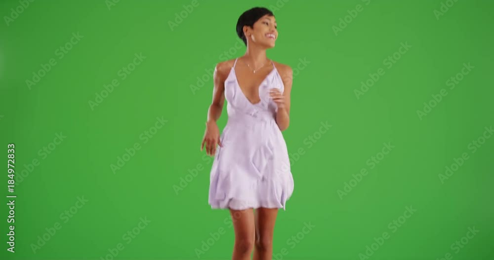 Beautiful black woman skips toward the camera on green screen. On green screen to be keyed or composited. Beautiful black woman skips toward the camera on green screen. On green screen to be keyed or composited.