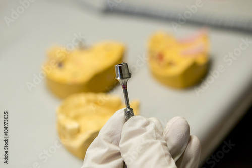 manual processing of the dental abutment close-up photo