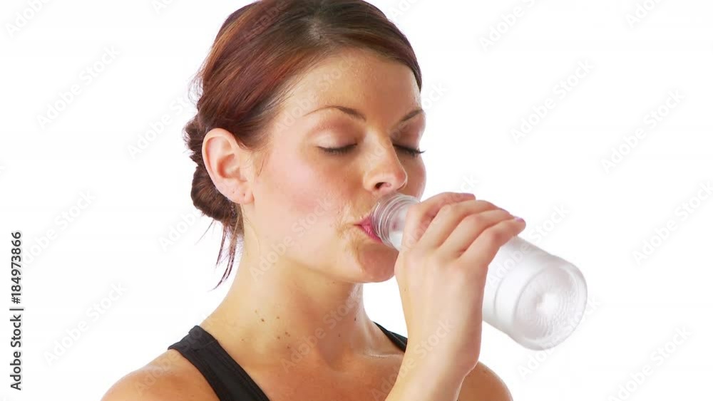 Sweaty woman drinking water after a workout Sweaty woman drinking water after a workout