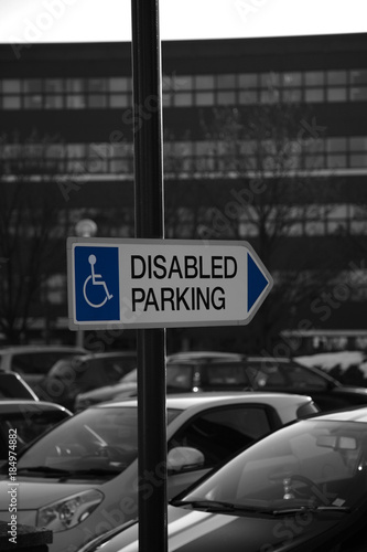 Disabled parking sign at a car park with selective color