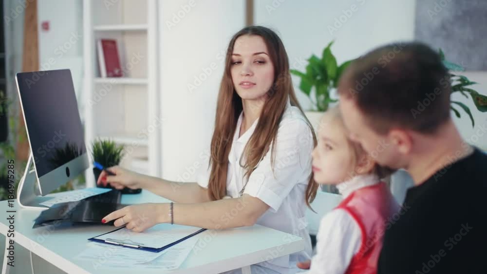 female doctor with x-ray talks to little girl female doctor with x-ray talks to little girl