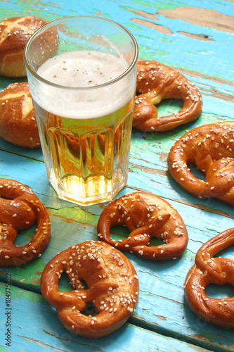 pretzels and a glass a glass of beer on wooden boards