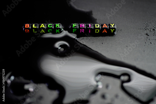 Black Friday, on liquid water, abstract shapes on a black backgr photo