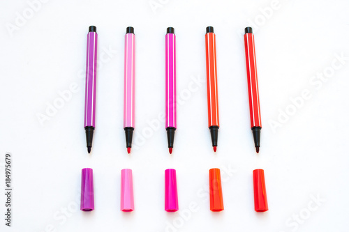 Colorful magic pens with cap isolated on white background. (Selective focus)