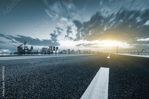 Asphalt highway and modern city buildings in hangzhou qianjiang new city at sunset photo