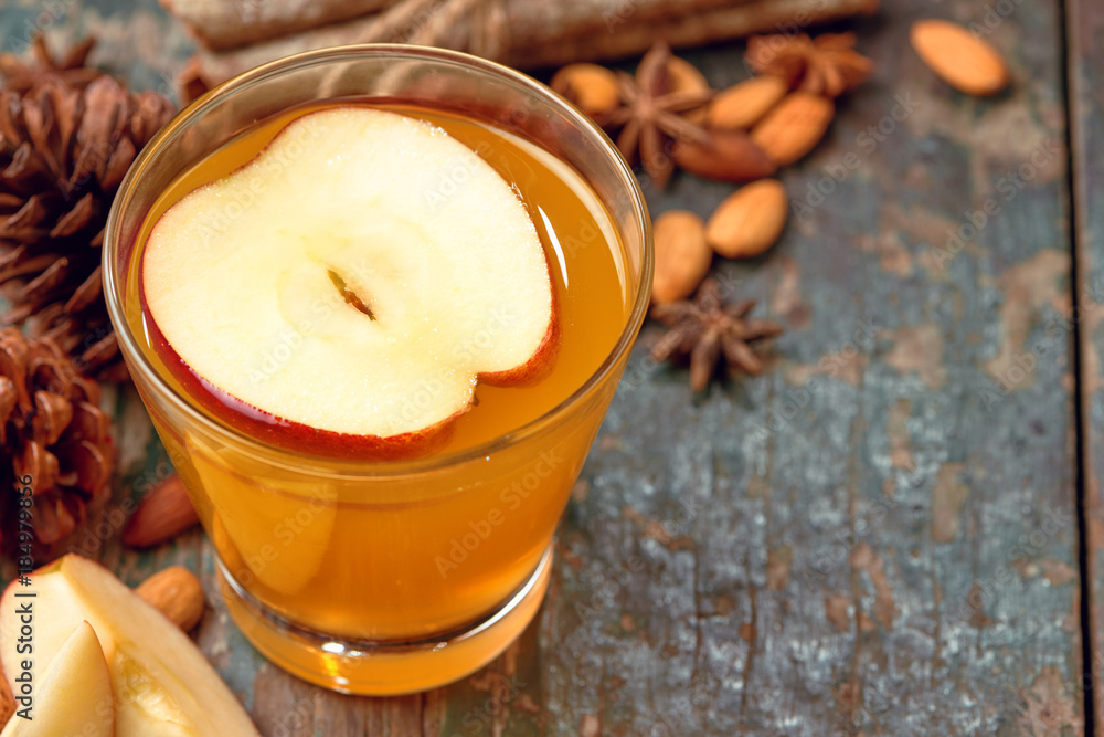 Hot drink of apple tea with cinnamon stick. Hot drink with apples for autumn or winter. Hot drink of apple tea with cinnamon stick. Hot drink with apples for autumn or winter.
