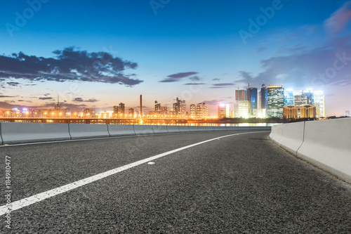 Asphalt highway and modern city buildings in hangzhou qianjiang new city at sunset
