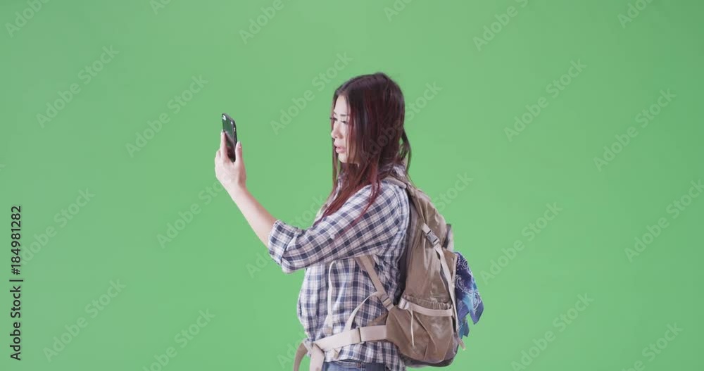 Asian woman can't get cell service in the desert on green screen. On green screen to be keyed or composited. Asian woman can't get cell service in the desert on green screen. On green screen to be keyed or composited.