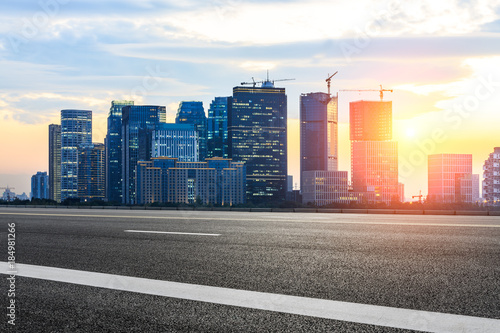 Asphalt highway and modern city buildings in hangzhou qianjiang new city at sunset photo