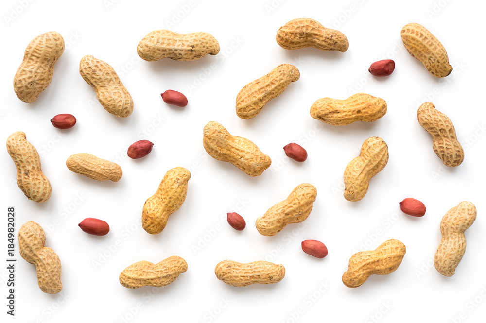 Creative peanut pattern. Isolated unpeeled groundnut and kernels. Top view. Creative peanut pattern. Isolated unpeeled groundnut and kernels. Top view.
