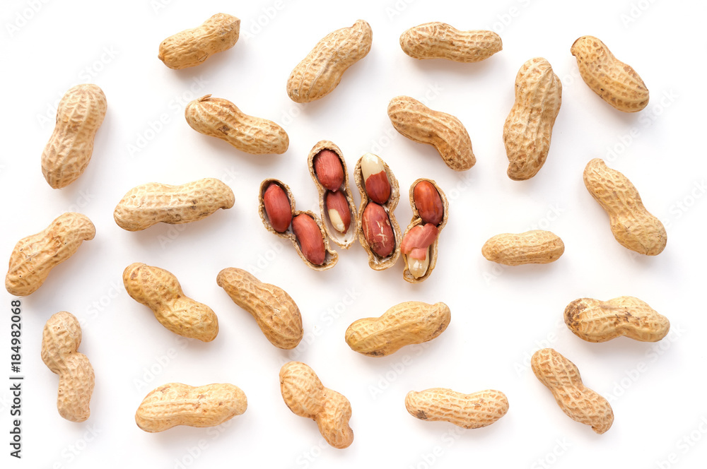 Isolated unpeeled groundnut and red seeds. Creative peanut pattern. Top view. Isolated unpeeled groundnut and red seeds. Creative peanut pattern. Top view.