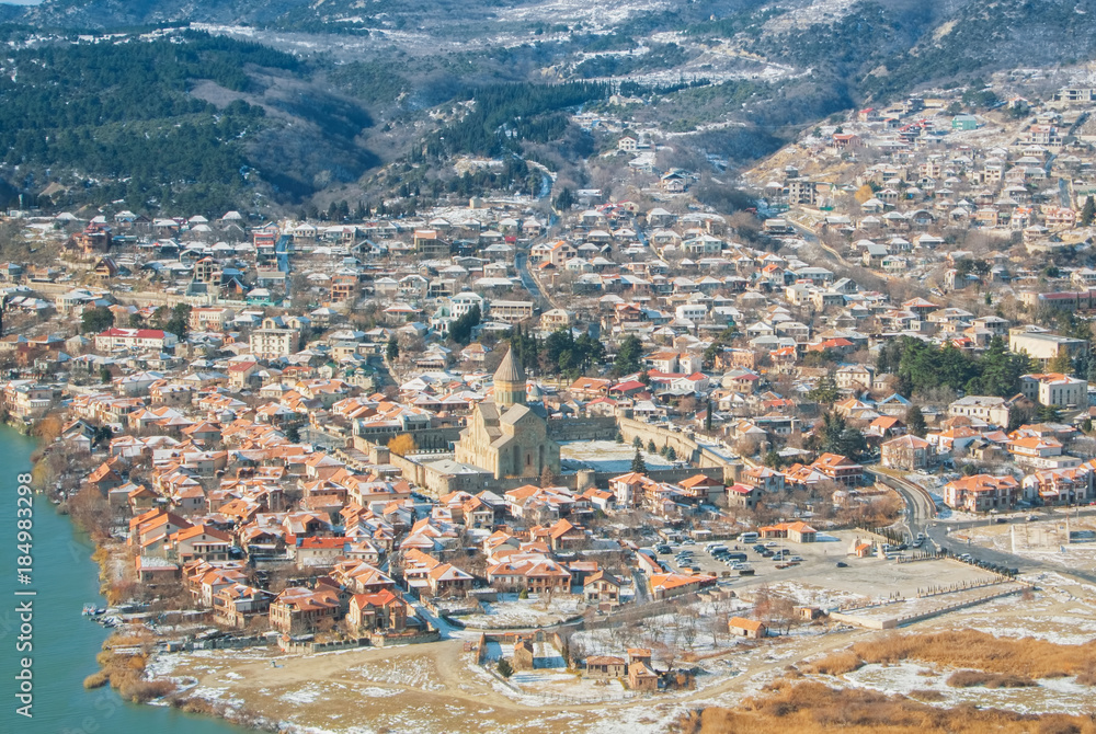Panoramic view of Mtskheta, an old town at the confluence of two rivers Mtkvari And Aragvi and Svetitskhoveli Cathedral, ancient georgian orthodox church, Unesco heritage, on winter sunny day.