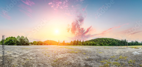 Park sand road large parking lot and green mountain nature landscape at sunset,panoramic view © ABCDstock