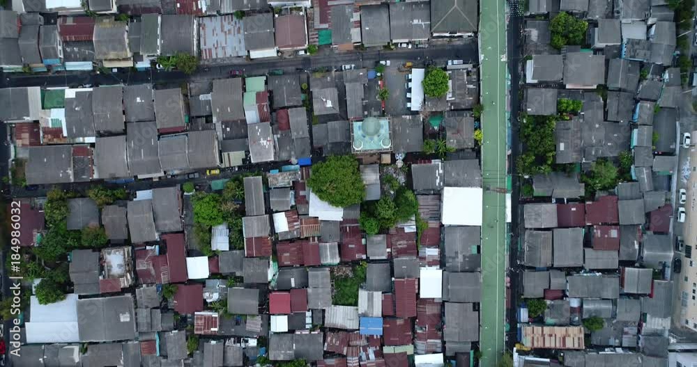 BANGKOK, THAILAND, MARCH 2017: Aerial over walkway passage trough housing area, mid day. BANGKOK, THAILAND, MARCH 2017: Aerial over walkway passage trough housing area, mid day.