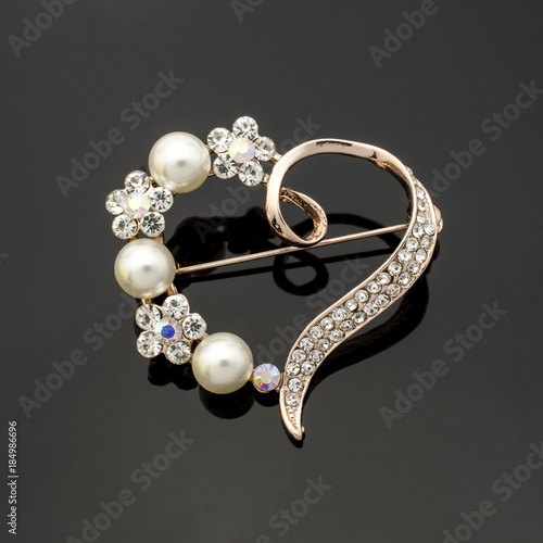 brooch heart with diamonds and pearls isolated on black