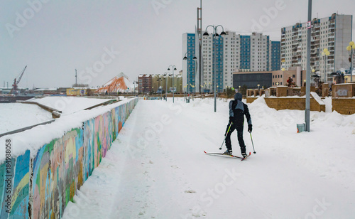 a man skis along the river photo