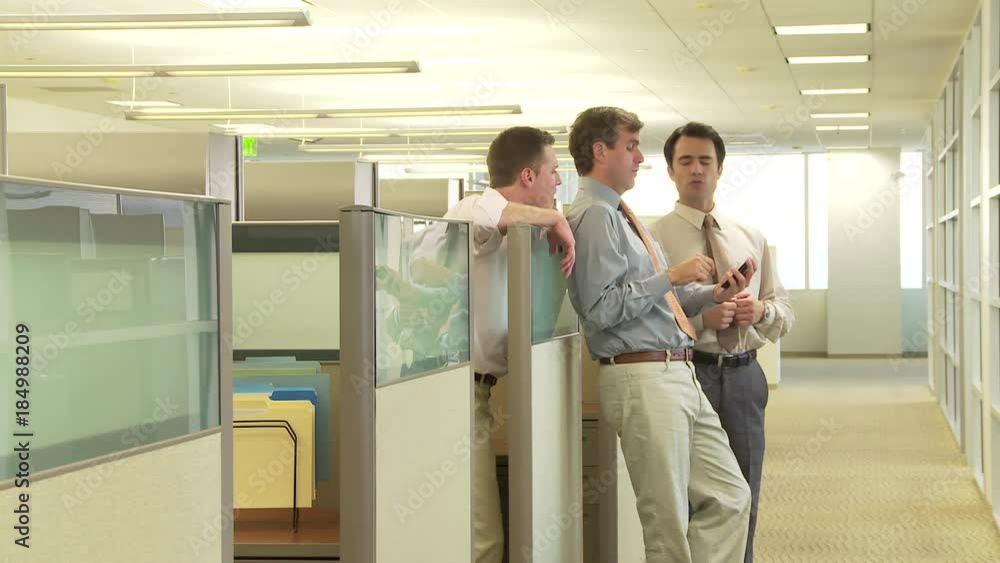 Business colleagues talking by office cubicle Business colleagues talking by office cubicle