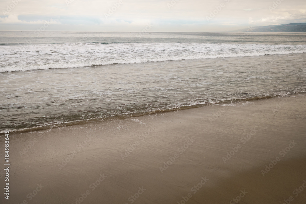 ocean waves on Santa Monica beach in cloudy november day ocean waves on Santa Monica beach in cloudy november day