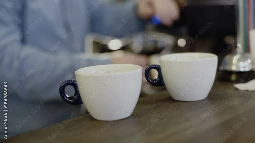 Barista's hands makes two coffee in coffee maker. 4K Barista's hands makes two coffee in coffee maker. 4K