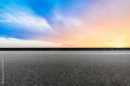Empty highway asphalt road and beautiful sky sunset landscape © ABCDstock