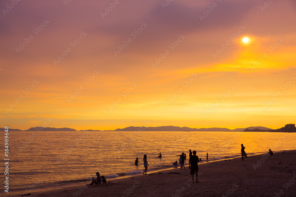 Silhouette people on beach in sunset time