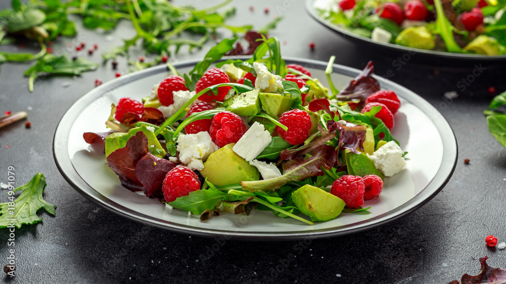 Fresh Tasty Raspberry salad with avocado, green vegetables, nuts, feta cheese, olive oil and herbs. healthy food. Fresh Tasty Raspberry salad with avocado, green vegetables, nuts, feta cheese, olive oil and herbs. healthy food.