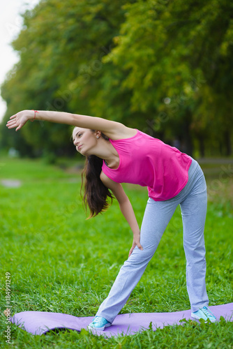 Girl doing gymnastic exercises or exercising outdoor