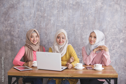 three siblings wearing hijab having project together
