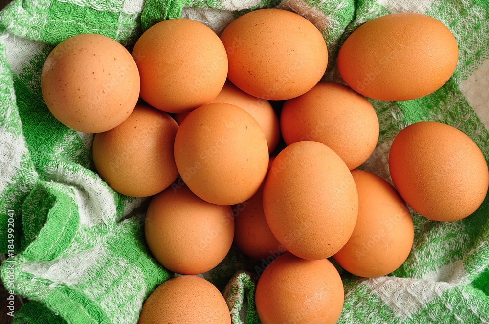Eggs in a green cloth inside a wire basket Eggs in a green cloth inside a wire basket