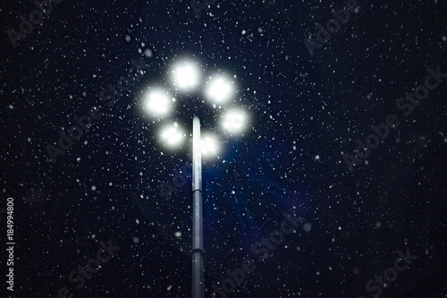 Snow falling in the light of a lantern